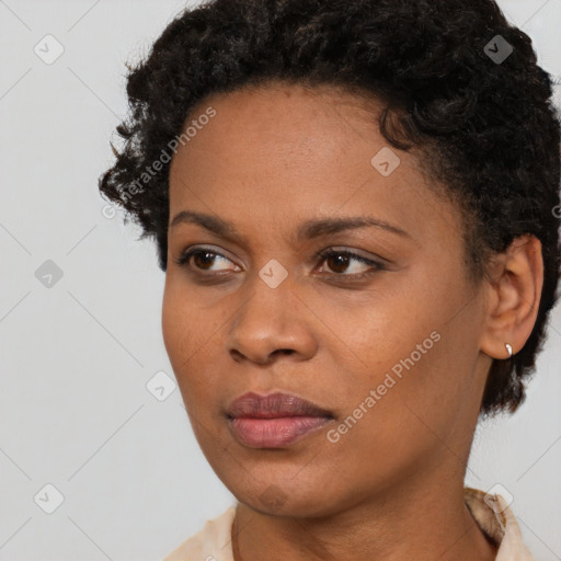 Joyful black young-adult female with short  brown hair and brown eyes