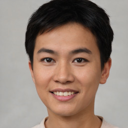 Joyful asian young-adult male with short  black hair and brown eyes