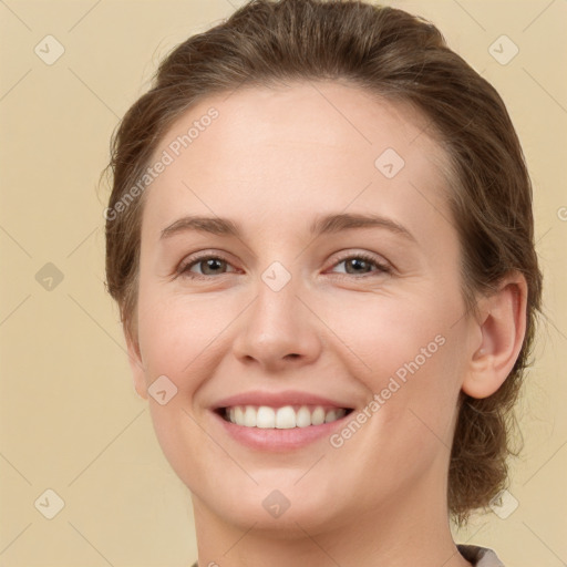 Joyful white young-adult female with medium  brown hair and green eyes