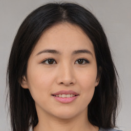 Joyful asian young-adult female with long  brown hair and brown eyes