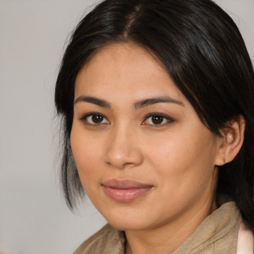 Joyful asian young-adult female with medium  brown hair and brown eyes