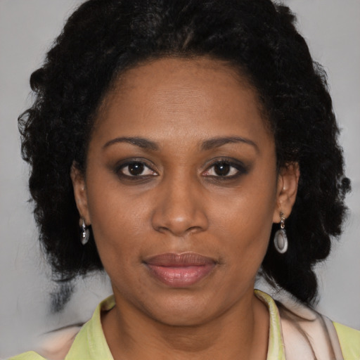 Joyful latino adult female with medium  black hair and brown eyes