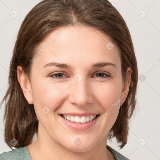 Joyful white young-adult female with medium  brown hair and grey eyes