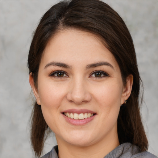 Joyful white young-adult female with medium  brown hair and brown eyes