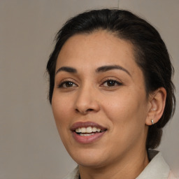 Joyful latino young-adult female with medium  brown hair and brown eyes