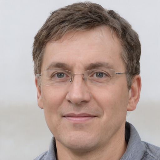 Joyful white adult male with short  brown hair and grey eyes