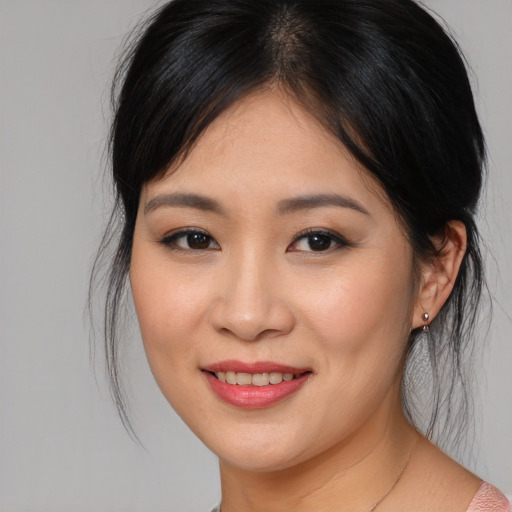 Joyful asian young-adult female with medium  brown hair and brown eyes