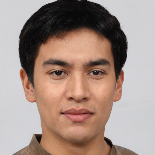 Joyful asian young-adult male with short  black hair and brown eyes