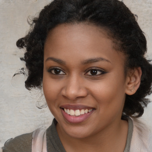 Joyful black young-adult female with medium  brown hair and brown eyes