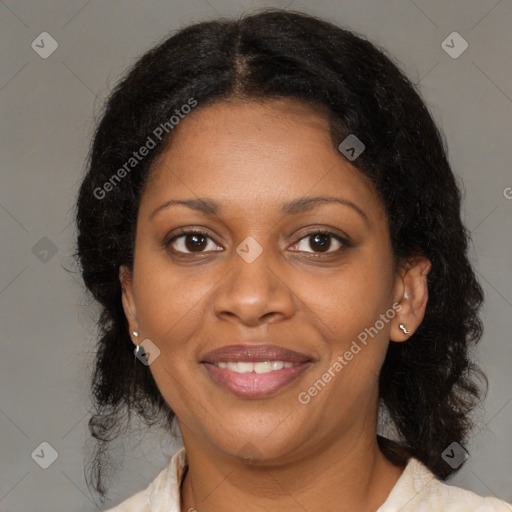 Joyful black adult female with medium  brown hair and brown eyes