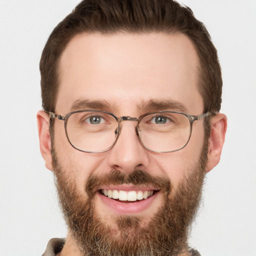 Joyful white adult male with short  brown hair and green eyes