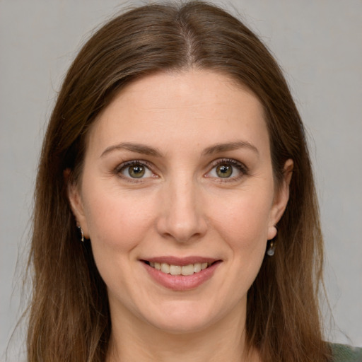 Joyful white young-adult female with long  brown hair and green eyes