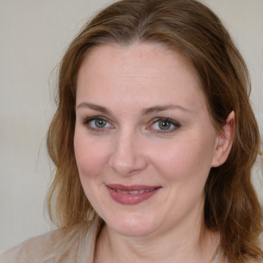 Joyful white young-adult female with medium  brown hair and blue eyes