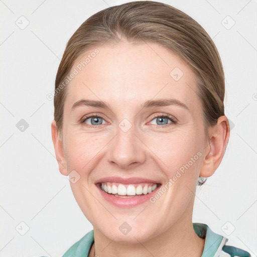 Joyful white young-adult female with medium  brown hair and blue eyes