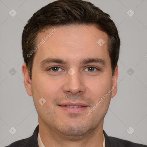 Joyful white young-adult male with short  brown hair and grey eyes