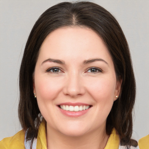 Joyful white young-adult female with medium  brown hair and brown eyes