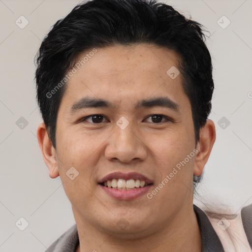 Joyful latino young-adult male with short  black hair and brown eyes