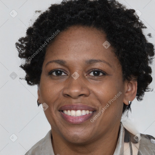 Joyful black adult female with short  brown hair and brown eyes