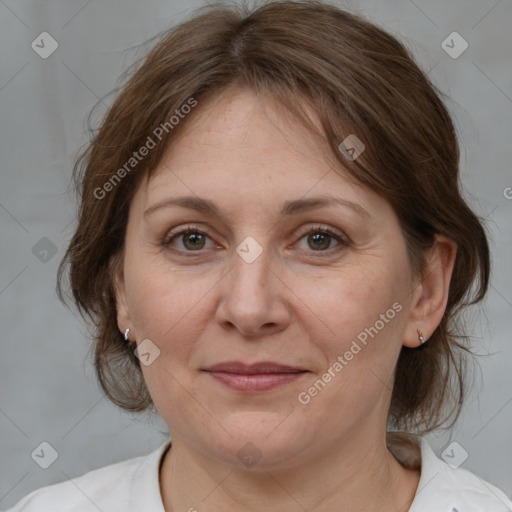 Joyful white adult female with medium  brown hair and grey eyes