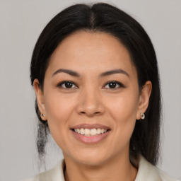 Joyful latino young-adult female with medium  brown hair and brown eyes