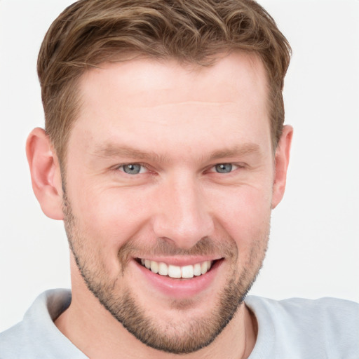 Joyful white young-adult male with short  brown hair and grey eyes