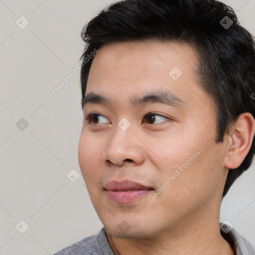 Joyful asian young-adult male with short  black hair and brown eyes