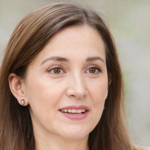 Joyful white adult female with long  brown hair and brown eyes