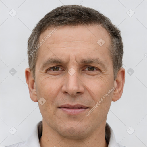 Joyful white adult male with short  brown hair and brown eyes