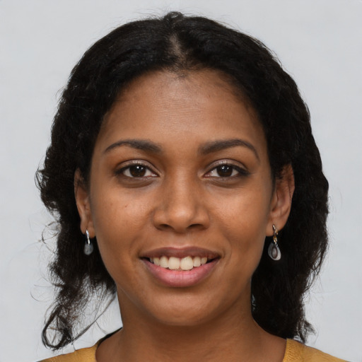 Joyful black young-adult female with short  black hair and brown eyes