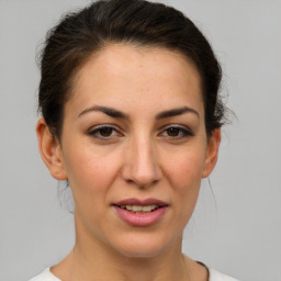 Joyful white young-adult female with medium  brown hair and brown eyes