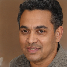 Joyful white adult male with short  black hair and brown eyes