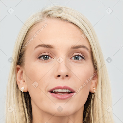 Joyful white young-adult female with long  brown hair and blue eyes