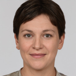 Joyful white adult female with short  brown hair and grey eyes