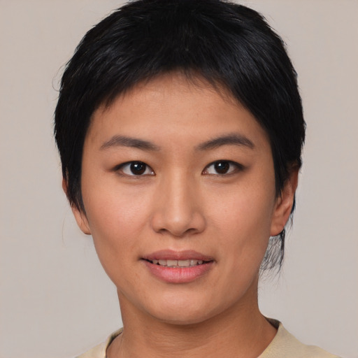 Joyful asian young-adult female with short  black hair and brown eyes