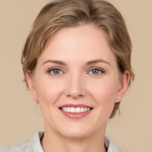 Joyful white young-adult female with medium  brown hair and grey eyes