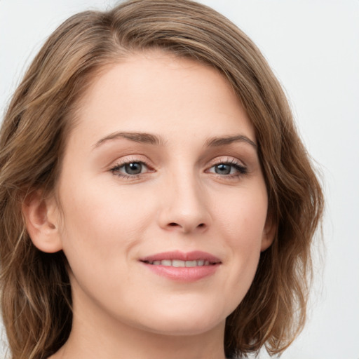 Joyful white young-adult female with long  brown hair and green eyes