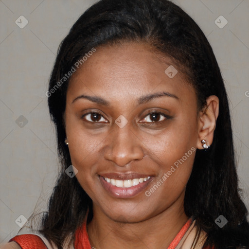 Joyful black young-adult female with long  brown hair and brown eyes