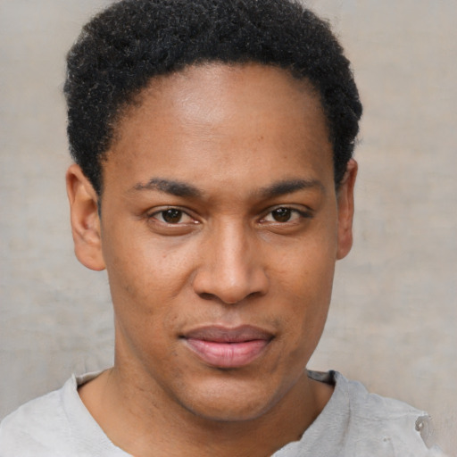 Joyful black young-adult male with short  brown hair and brown eyes