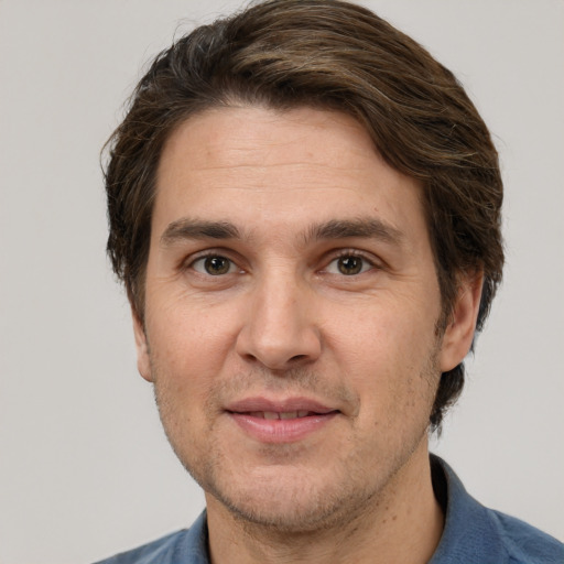 Joyful white adult male with short  brown hair and brown eyes