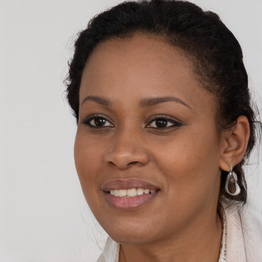 Joyful black young-adult female with medium  brown hair and brown eyes