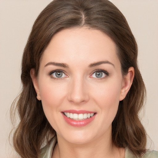 Joyful white young-adult female with medium  brown hair and green eyes