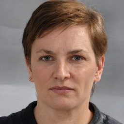 Joyful white adult female with short  brown hair and grey eyes