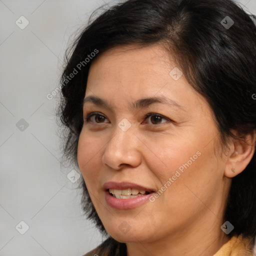 Joyful white adult female with medium  brown hair and brown eyes