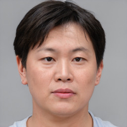 Neutral asian adult male with short  brown hair and brown eyes