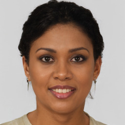 Joyful black young-adult female with short  brown hair and brown eyes