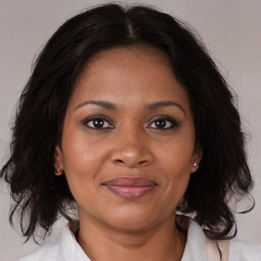 Joyful black young-adult female with medium  brown hair and brown eyes