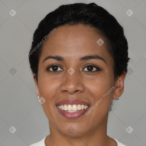 Joyful black young-adult female with short  black hair and brown eyes