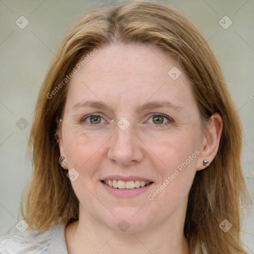 Joyful white adult female with medium  brown hair and blue eyes