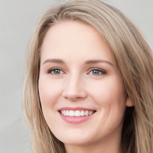 Joyful white young-adult female with long  brown hair and grey eyes