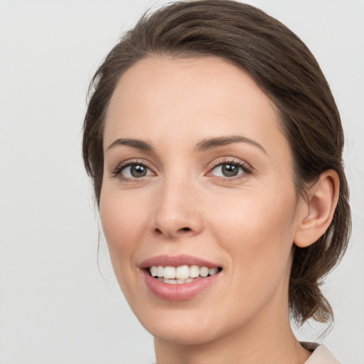 Joyful white young-adult female with medium  brown hair and brown eyes